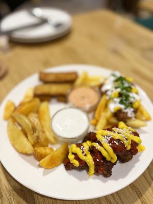 Super future mix: loaded fries, village potato, crispy sticks, bbq bites, vegan mayo, cocktail sauce at Future Diner in Yerevan