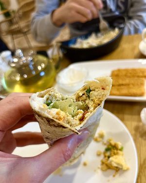 Juicy wrap with tofu scramble, spice mix, tomato, green onion and salad  at Future Diner in Yerevan