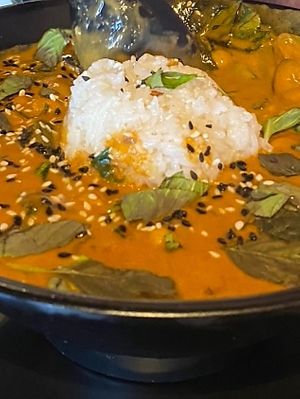 Panang Curry - amazing balance of spices and creaminess! The basil and seasame seeds top it off just right! Generous serving in a deep bowl! Not cheap tricks here!  at Voodu Vegan Bistro in Tampa