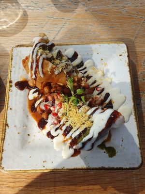 VEGAN SAMOSA CHAAT: Punjabi filo pastry stuffed with vegetables on a bed of chickpeas, Mint, tamarind & vegan yogurt at Delhi House Cafe in Manchester
