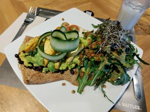 Sweet crêpe with fried beans and lentils, avocado, sautéed tofu, rocket, etc. And sour sop water shake. All vegan. at Crepes & Waffles in Medellin