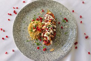 Imam Bayildi - Grilled Aubergine stuffed with Plant-based Mince, Pomegranate, Almond, Bulgur Wheat and Vegan Yoghurt Dressing at Woodland Manor Hotel & Restaurant in Clapham