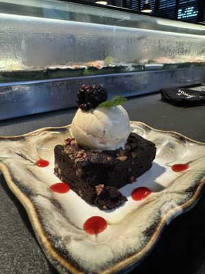 The vegan soft brownie with dripping coconut ice cream laced with strawberry syrup and topped with a blackberry   at Hiromi in Cancun