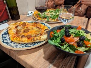 Half-vegan chorizo pizza with salad at Bella Vita in Strasbourg