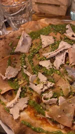 Pizza with pesto, vegan mortadella and tofu!  at Rosso Verace in Alcamo