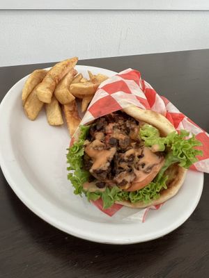 Vegan Gyro-House made seitan, sautéed onions and peppers, lettuce, tomatoes topped with veganaise and special sauce. Served with a side of fries.  at Vegelicious Antioch in Antioch