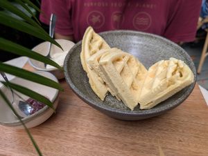 Yuca waffles served with a teaspoon of jam and cashew cream at W h o l l y in Medellin