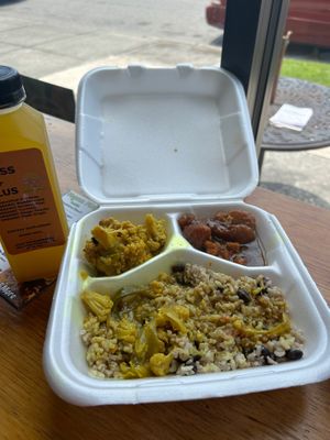 Curry cauliflower wings with rice/peas. Very little food overall and the rice/peas was cold. This meal and beverage was not worth paying $25. at Vegan Planet Café in Norfolk