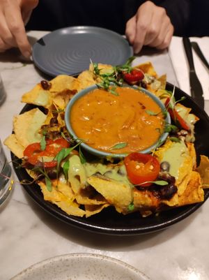 Shared starter. Nachos. Very tasty - huge bowl of sauce for quantity of chips. at Mildreds - Covent Garden in London