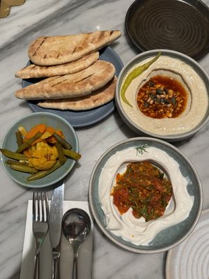 Taste of Mildred’s menu: Rainbow pickles, taktouka whipped mascarpone, salsa macha hummus & pita.  at Mildreds - Covent Garden in London