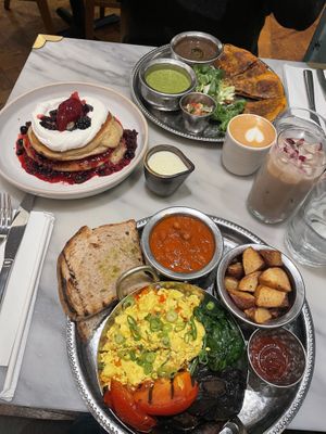 Full English breakfast (bottom), berries and cream pancakes (left), mananero brunch (top)  at Mildreds - Covent Garden in London
