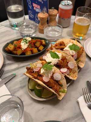 Harissa Patatas Bravas (background) and Chipotle Chick+n Tinga Tacos (foreground) at Mildreds - Covent Garden in London