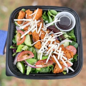 Our famous WIAV Super Salad. Our Signature Wingz accompanied by our mix of Organic house greens, fresh tomatoes, cucumbers and onions and a blend of dairy free mozzarella Cheez!! at Where It All Vegan in Gahanna