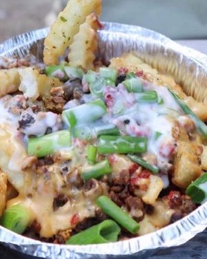 This what we mean when we say a (Loaded Fry). House made Cheez, Sour Cream, Onions, Meatless Crumbles, Bacon Bits and the rest is history!! at Where It All Vegan in Gahanna