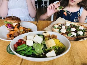 Vegan double cheeseburger, kale salad with grilled tofu, and spinach cashew-ricotta pizza. So delicious! at True Food Kitchen in Santa Monica