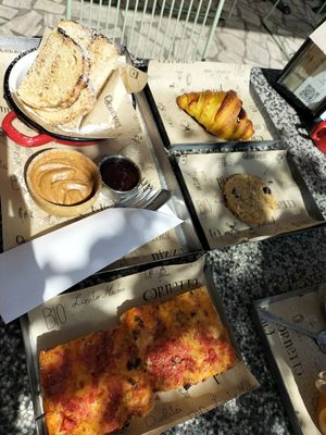 Cherry croissant, cookie, bread peanut butter and jam, tomato pizza at Qcorner in Forli