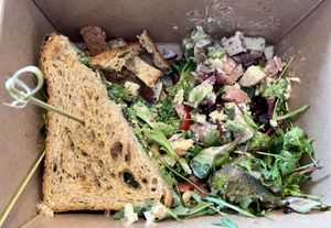 Vegan Chickpea Salad sandwich, potato salad, green salad, halfway through!   at Magdelena's in Petaluma