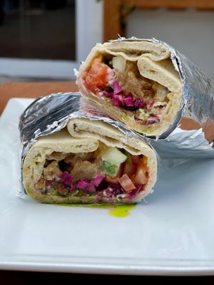 Crazy Cauli- FRIED SEASONED CAULIFLOWER,
HUMMUS, TOMATO, CUCUMBER, PICKLED
CABBAGE, CARAMELIZED ONIONS, PITA
CHIP CRUMBLES, TAHINI, CHERMOULA 100% vegan at Meze Morada in Islamorada