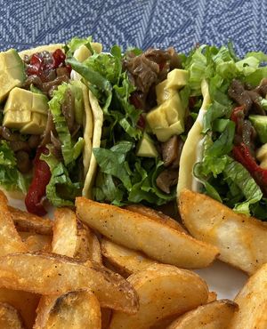 Mushroom tacos with potato wedges. at Tulsi Cafe y Plantas in Ciudad Colon