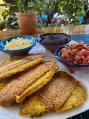 Patacones (fried green plantains) is a traditional Costa Rican snack. Ours comes with beans, cheese (optional) and home-made salsa. at Tulsi Cafe y Plantas in Ciudad Colon