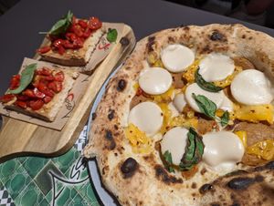 La diavola vegan pizza. Notice unmelted mozzarisella and a lot of bare crust. + Bruschetta. at Assaje in Trieste