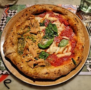 Half vegan mortadella and pistachio and half vegan margherita at Assaje in Trieste