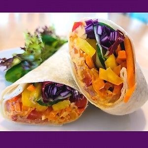 Vegan roasted red pepper hummus wrap with fresh vegetables at The Café in Little Falls