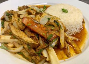 tofu sautéed with onions and tomatoes; served on a bed of fries, with a side of rice. at Aji Peruvian Restaurant in Ooltewah