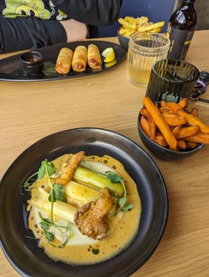 Braised leeks, parsnip puree, oyster mushrooms and creamy sauce, krab spring rolls & a side of sweet potato fries at Mangosteen in Portsmouth