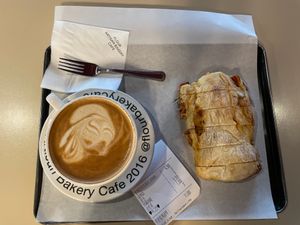Hot oat latte and tomato marinade ciabatta  at Flour Artisan Bakery in Seoul