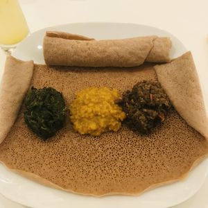 The three stews avec injera   at Vegitopia in Brussels