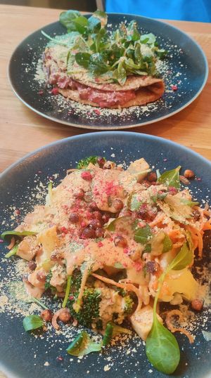 Salad with vegetables and spicy peanut sauce and pancake filled with mushrooms and beetroot pesto. at Trip Cafe in Tallinn