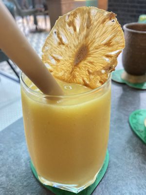 Mango juice with a tasty pineapple crisp  at The Vegan Table in Bangkok