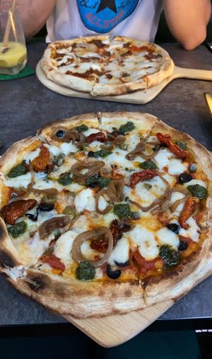 Mediterranean pizza (front) and pepperoni pizza (back)  at The Vegan Table in Bangkok