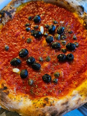 Pizza marinara with added olives and capers at Bella Napoli in Orzinuovi