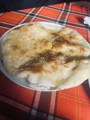 Turkish flatbread includes sesame seeds and melted butter (vegan available - ask for no butter).  at Sunny's in Borovets