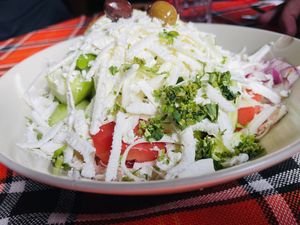 Salad with cucumbers, tomatoes, peppers, onions, olives, and fresh grated cheese (vegans as for no cheese - if they have extra beans, nuts, or seeds they cab sprinkle them on top). at Sunny's in Borovets