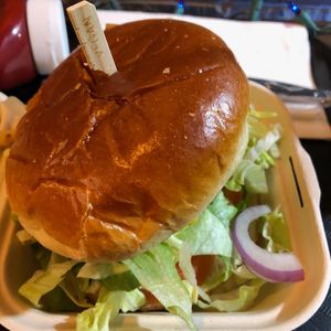 Really good fried seitan cutlet, tasty sauce, piled with lettuce, pickles and onions, on a big brioche bun.   at Vegan Grill - St Marks in New York City