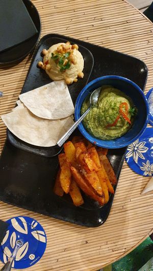 Hummus, broccoli guacamole and spiced potato wedges at Drinks & Co in Paris