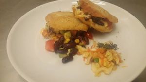 Arepas(colombian corn bread) with red beans, corn, tomato, cheese and avocado. Salad is carrot raisins and chinese cabbage. at Govinda's Restaurant in Septon