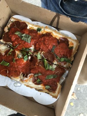 Detroit style pizza with vegan cheese + pepperoni   at Peels On Wheels in Rochester