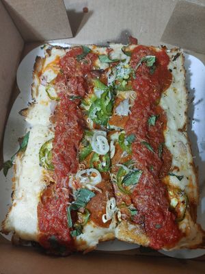 Vegan Detroit style pizza with jalapenos shallot vegan cheeses and vegan pepperoni at Peels On Wheels in Rochester