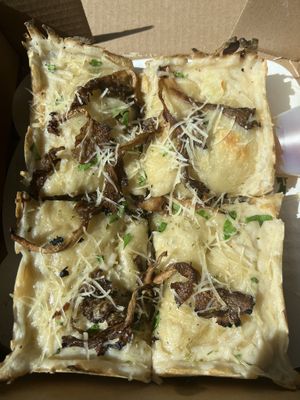 Detroit style vegan tartufo with Numu cheese on the perimeter. Side of vegan honey drizzle. 👌  at Peels On Wheels in Rochester