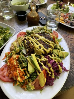 Cosmic crazy veggie loving salad with extra sauerkraut and an added burger patty. at Naked Foods in Nosara