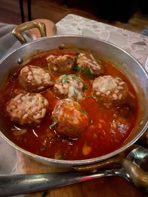 Puttanesca “Meatballs” ($18) - Lemon brown butter sauce, capers, kalamata olives, roma tomatoes, “mozzarella,” parsley garlic knots at Coletta in New York City