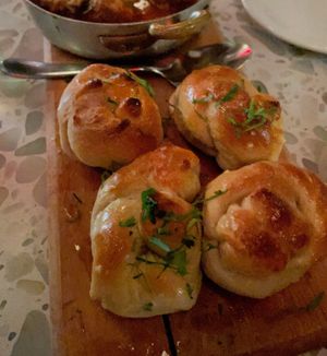 Puttanesca “Meatballs” ($18) - Lemon brown butter sauce, capers, kalamata olives, roma tomatoes, “mozzarella,” parsley garlic knots at Coletta in New York City