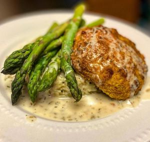 Chik’n with feta herb cream, rice pilaf and asparagus  at The Sweet Botanist Plant Based - Cloud Kitchen in Dallastown