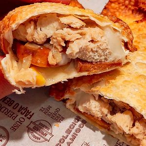 homemade pastry: vegetable chicken, vegetable pepperoni onion, vegetable catupiry, corn, chopped tomato and vegetable bacon at Um Sonho de Coxinha (Cantina Vegana) in Sao Paulo