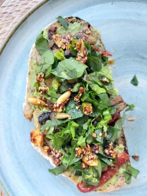 Avocado toast with dried tomatoes, mushrooms and spinach. at Trastévere in Valle De Bravo