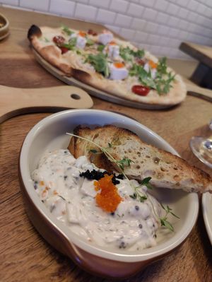 Toast Skagen and a löjroms pizza in the background at Veganska Ölbaren in Stockholm